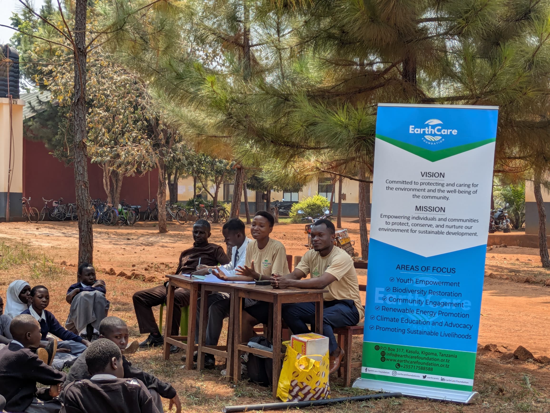 Outdoor learning session with EarthCare banner