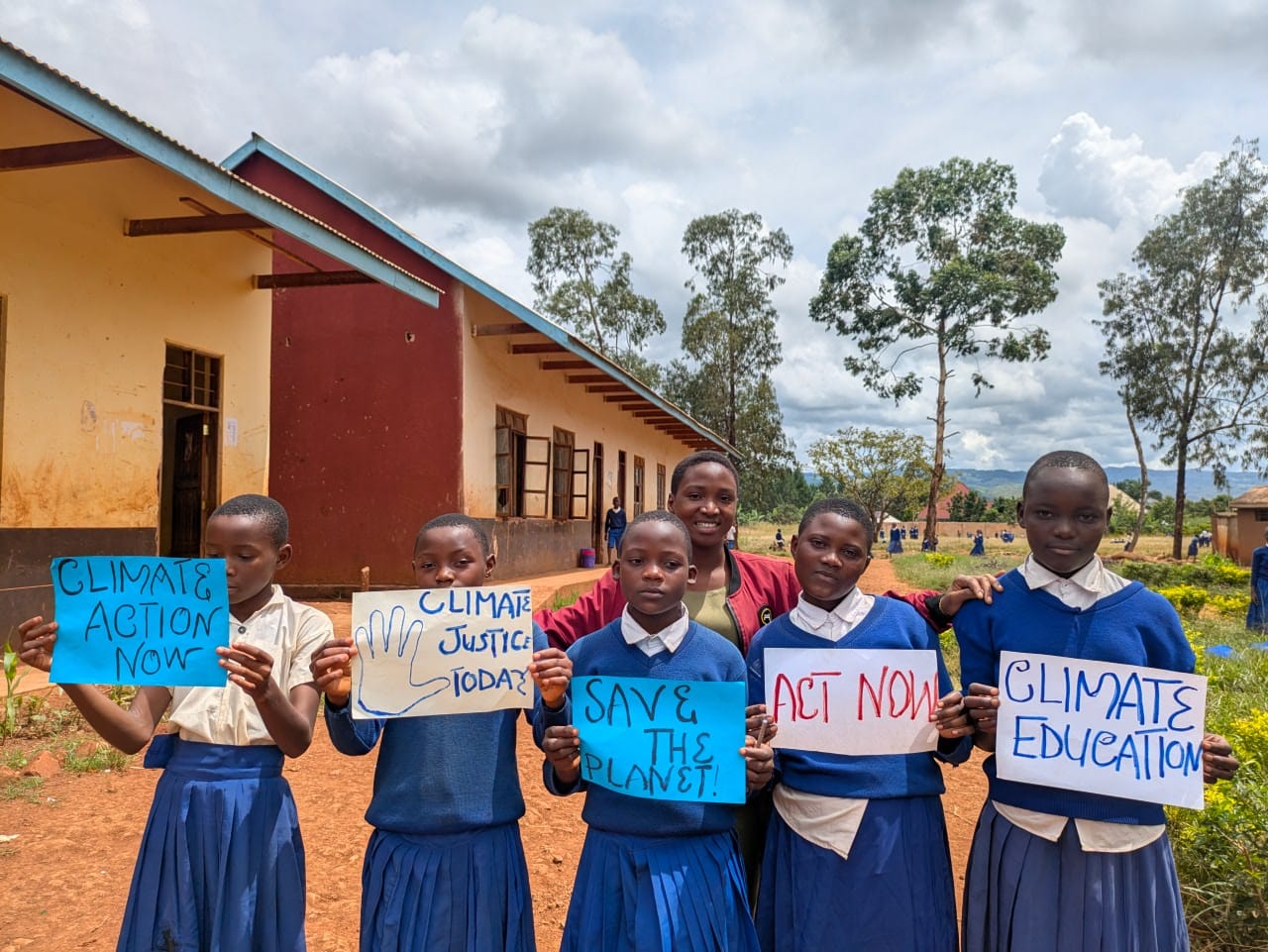 Students in Kasulu holding climate action signs