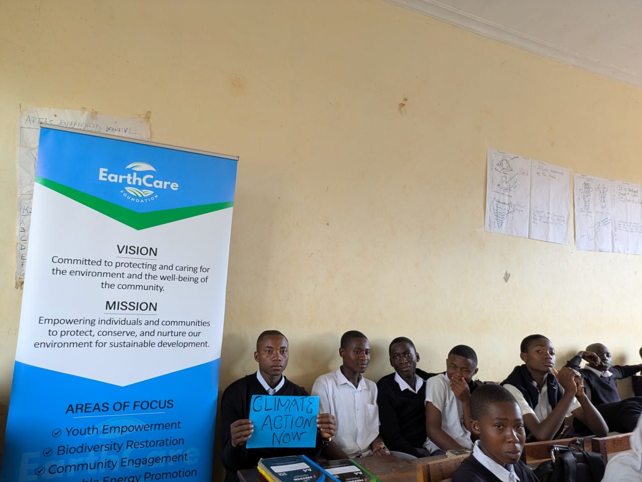 EarthCare Foundation organization banner at a school activity